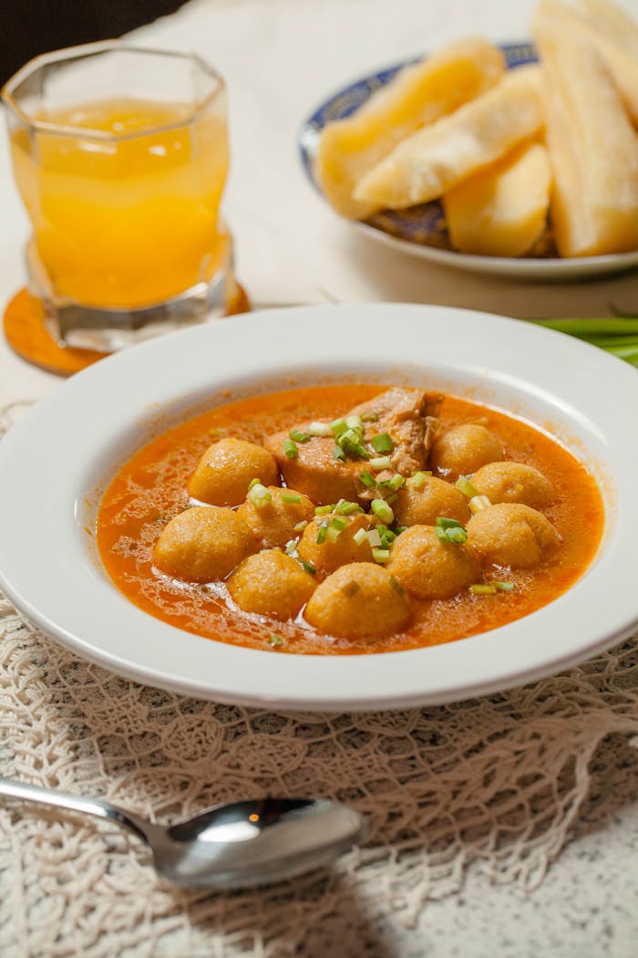 gallery-1 Homemade Paraguayan soup with cassava and a glass of juice on the side.